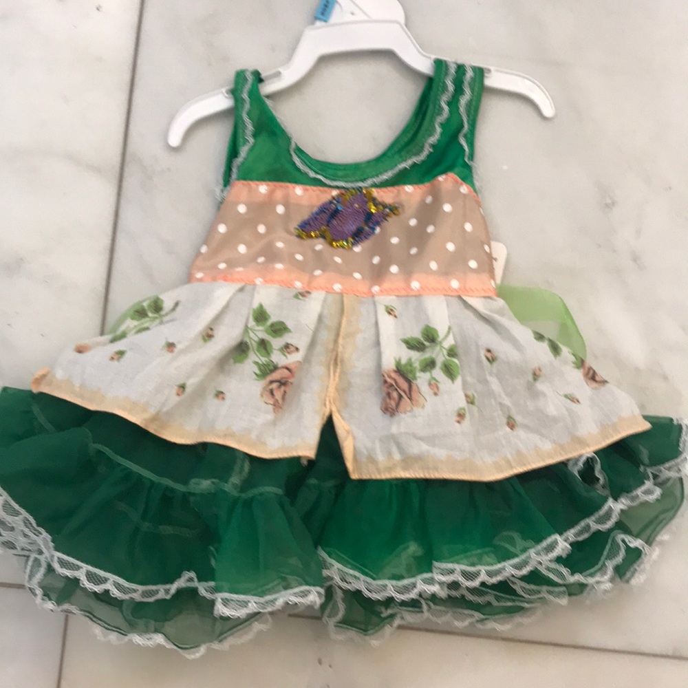 Baby dress with green ruffles